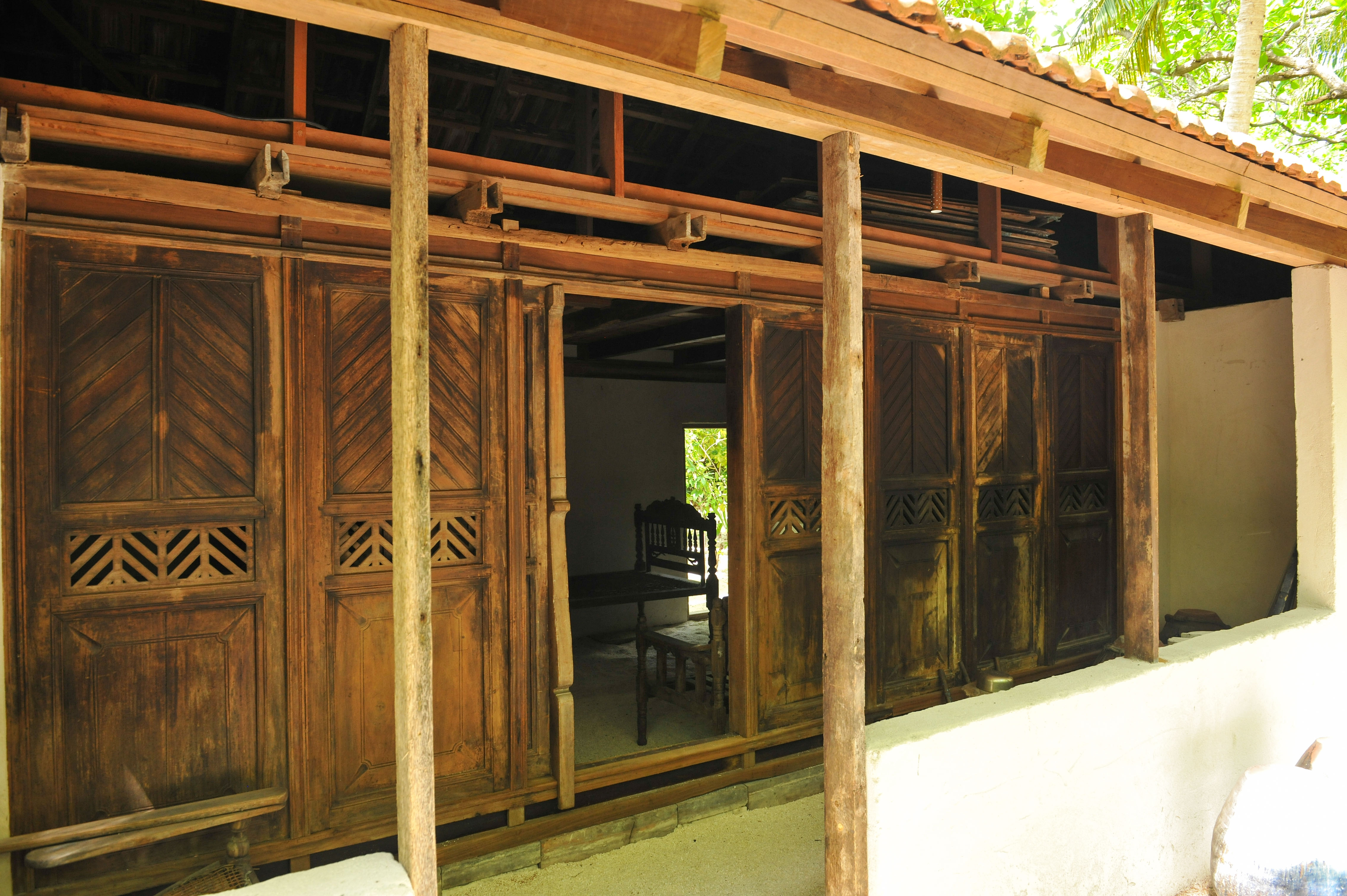 Traditional Maldivian island house with a shaded veranda